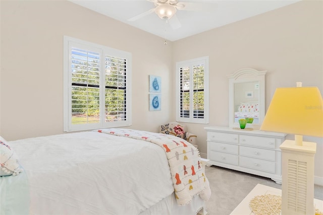 bedroom featuring light carpet and ceiling fan