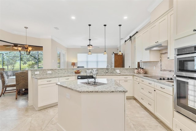 kitchen featuring black electric stovetop, under cabinet range hood, a peninsula, backsplash, and crown molding