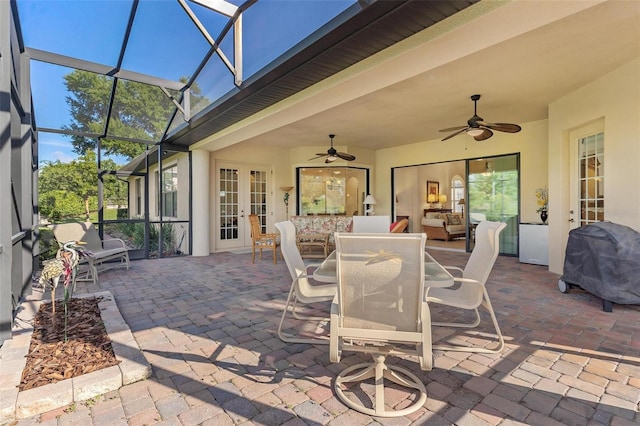 view of patio with french doors, a ceiling fan, glass enclosure, a grill, and an outdoor living space