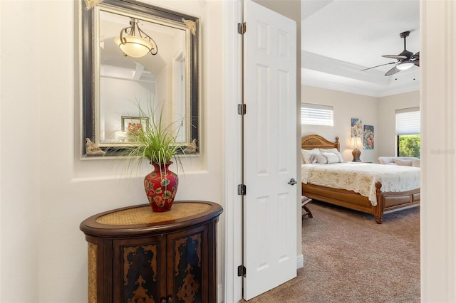 bedroom featuring carpet, ornamental molding, and a ceiling fan