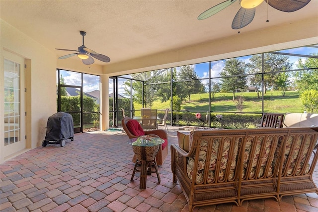 sunroom / solarium with a ceiling fan