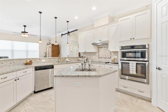 kitchen with stainless steel appliances, crown molding, under cabinet range hood, white cabinetry, and backsplash