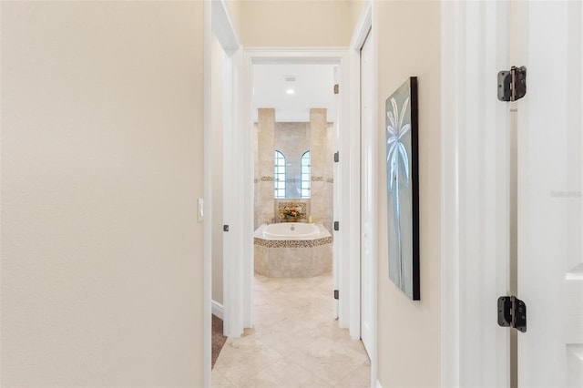 hall featuring light tile patterned floors