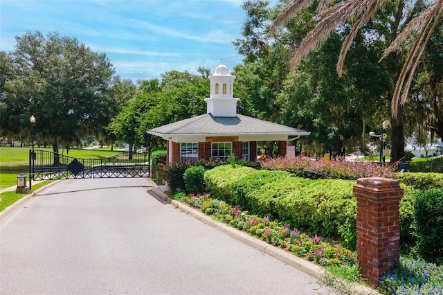 view of community featuring a yard and a gate