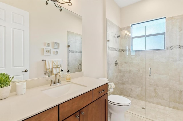 bathroom featuring a stall shower, vanity, and toilet