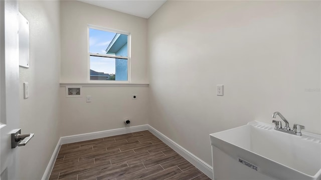 laundry area with dark wood-type flooring, hookup for a washing machine, sink, and hookup for an electric dryer