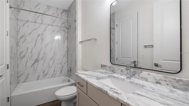 full bathroom with vanity, toilet, and tiled shower / bath combo