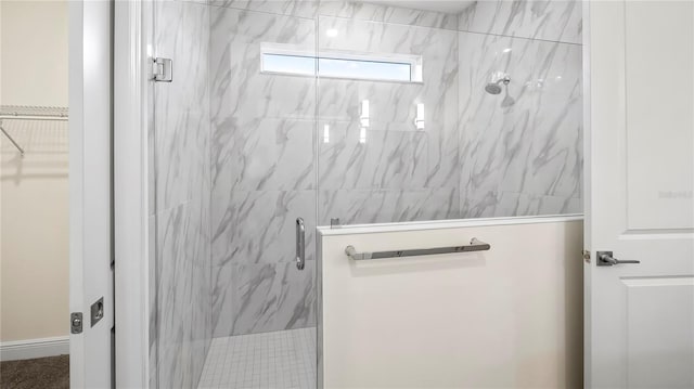 bathroom with a shower with door