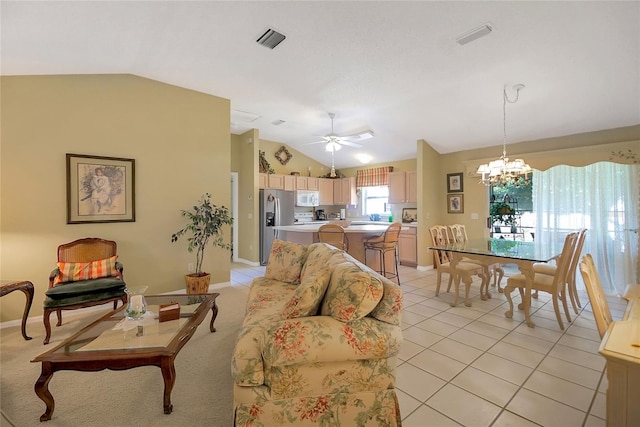 living room with visible vents, baseboards, light tile patterned flooring, vaulted ceiling, and ceiling fan with notable chandelier