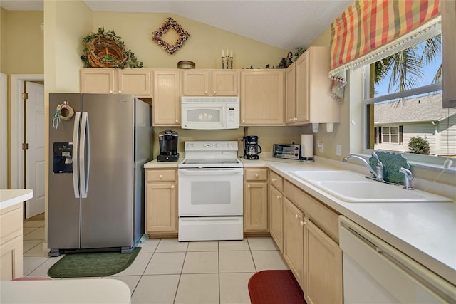 kitchen featuring light tile patterned floors, light countertops, light brown cabinets, a sink, and white appliances