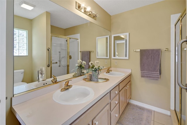 full bath with double vanity, a stall shower, and a sink