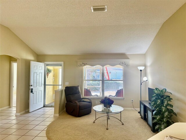 1213 El Esparza Ln, The Villages, FL 32159 - sitting room featuring a textured ceiling, arched walkways, lofted ceiling, and light tile patterned floors