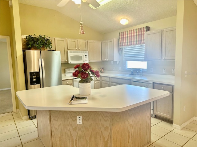 1213 El Esparza Ln, The Villages, FL 32159 - kitchen with white appliances, light tile patterned floors, lofted ceiling, a center island, and light countertops
