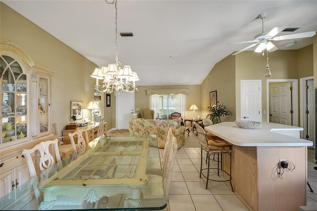 dining room with vaulted ceiling, light tile patterned floors, ceiling fan with notable chandelier, and visible vents