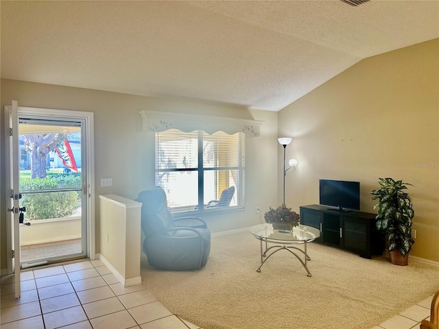 tiled living room with vaulted ceiling, a textured ceiling, and baseboards