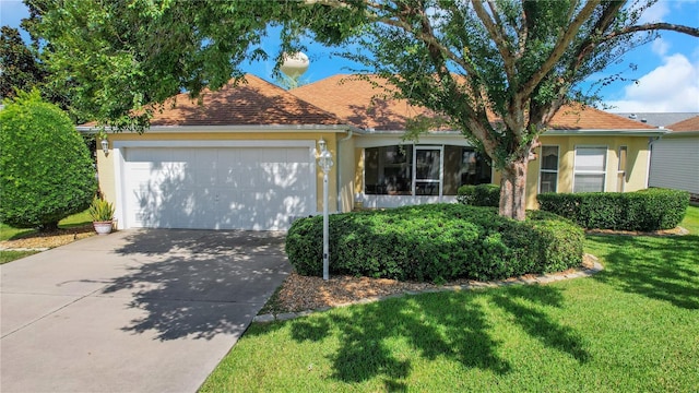 single story home featuring a garage, a shingled roof, concrete driveway, stucco siding, and a front yard