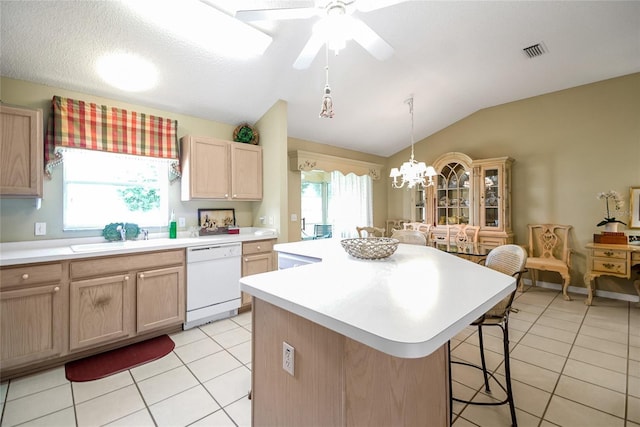 1213 El Esparza Ln, The Villages, FL 32159 - kitchen featuring dishwasher, vaulted ceiling, light tile patterned floors, a kitchen island, and light countertops