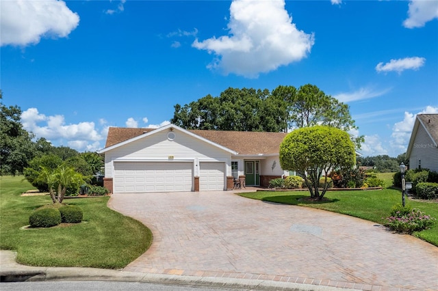 ranch-style home with a garage and a front lawn