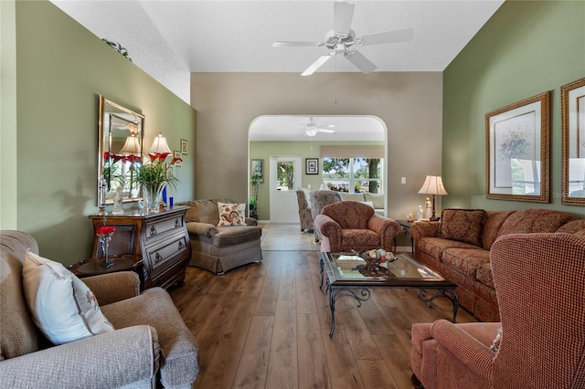 living room featuring ceiling fan, dark hardwood / wood-style floors, and a textured ceiling