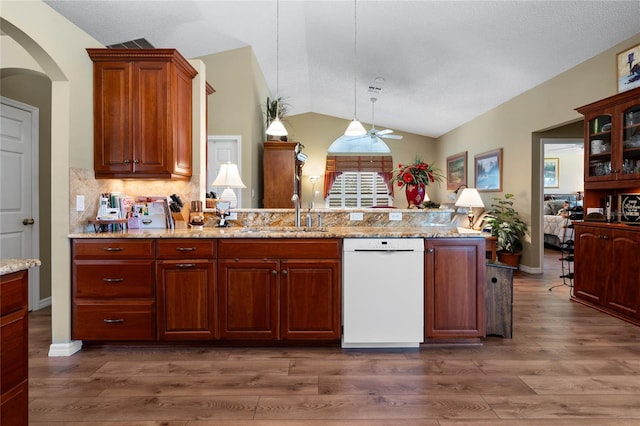 kitchen featuring lofted ceiling, white dishwasher, sink, and dark hardwood / wood-style floors