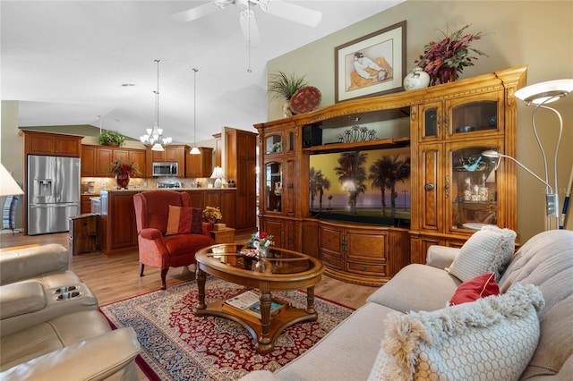 living room with light hardwood / wood-style flooring, vaulted ceiling, and ceiling fan with notable chandelier