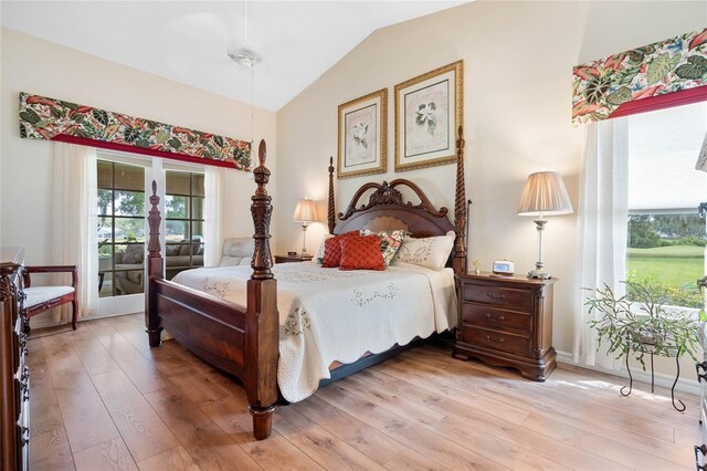 bedroom featuring lofted ceiling and light hardwood / wood-style floors