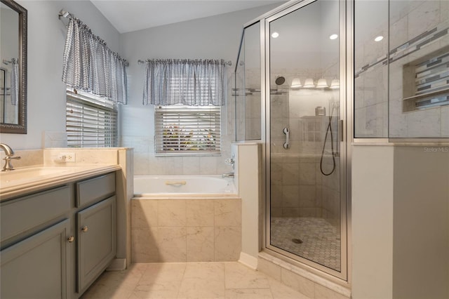 bathroom featuring lofted ceiling, shower with separate bathtub, and vanity