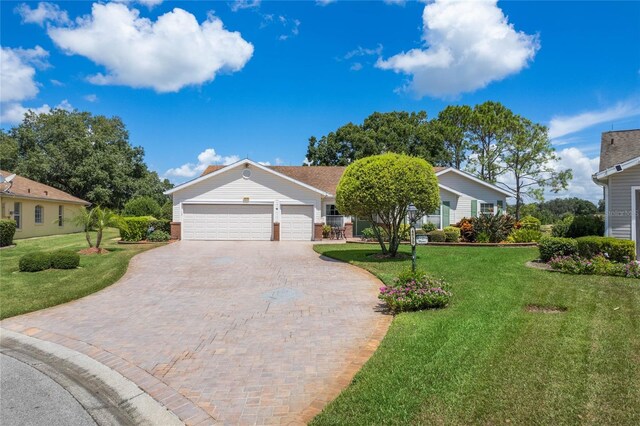 view of front of home featuring a garage and a front yard