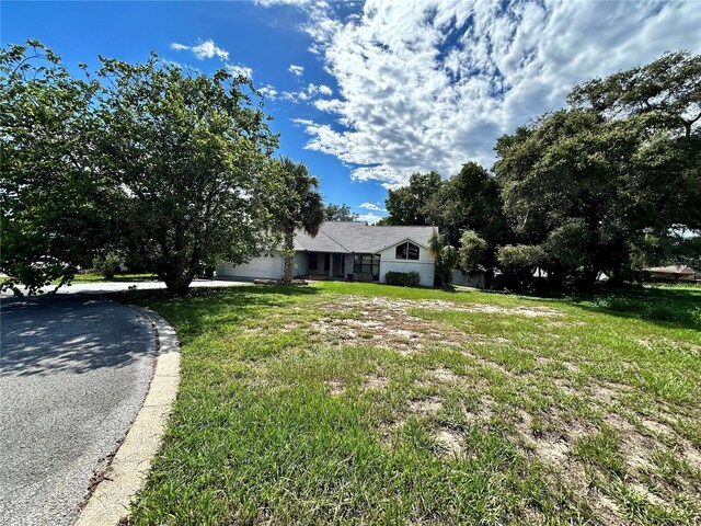 view of front of property with a front yard and a garage