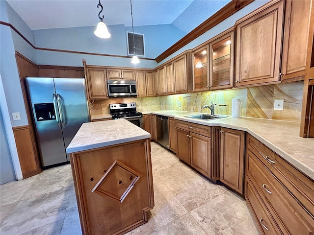 kitchen with a kitchen island, stainless steel appliances, hanging light fixtures, vaulted ceiling, and backsplash