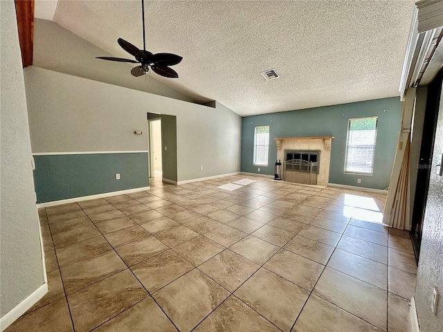 unfurnished living room with lofted ceiling, ceiling fan, light tile patterned flooring, and a textured ceiling