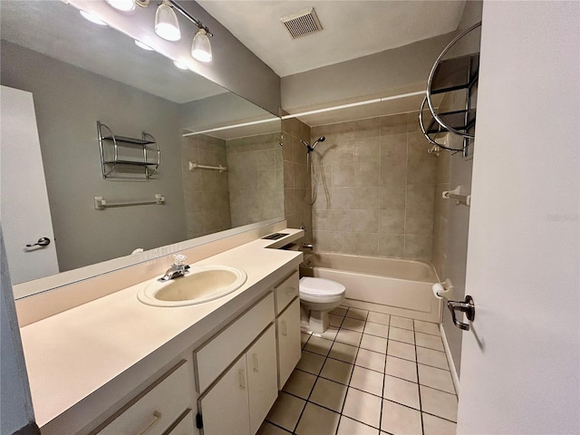 full bathroom featuring tile patterned flooring, tiled shower / bath, vanity, and toilet