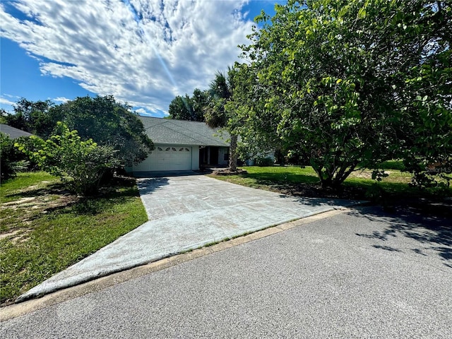 view of front of property featuring a garage and a front lawn