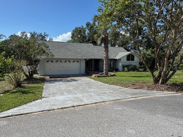 ranch-style house featuring a garage and a front yard