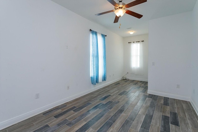 spare room featuring dark wood-type flooring and ceiling fan