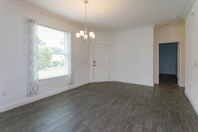 empty room featuring an inviting chandelier, dark hardwood / wood-style flooring, and ornamental molding