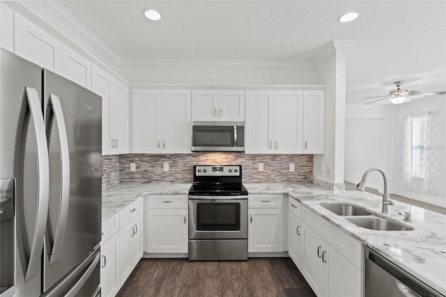 kitchen with stainless steel appliances, white cabinetry, and sink