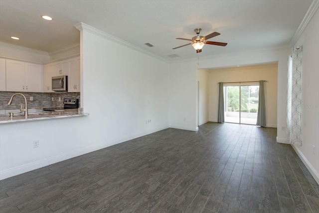 unfurnished living room with ceiling fan, crown molding, dark hardwood / wood-style floors, and sink