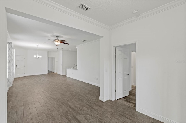 unfurnished living room featuring ceiling fan with notable chandelier, dark wood-type flooring, and crown molding