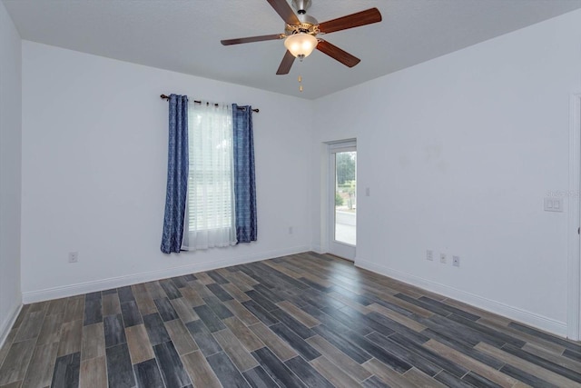 spare room featuring ceiling fan and dark hardwood / wood-style flooring