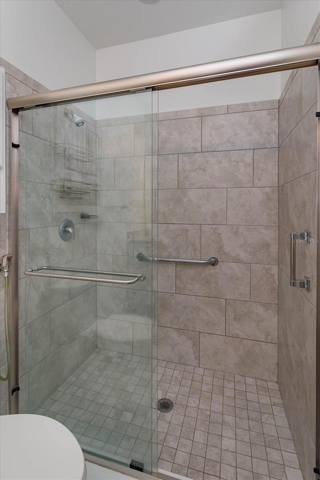 bathroom featuring toilet and walk in shower