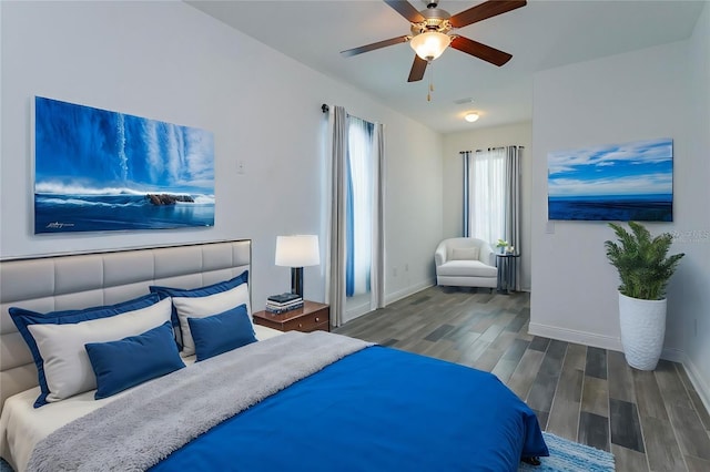 bedroom with ceiling fan and dark hardwood / wood-style flooring