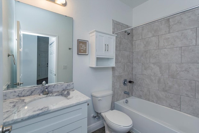 full bathroom featuring toilet, vanity, and tiled shower / bath