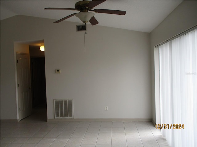 empty room featuring ceiling fan and vaulted ceiling