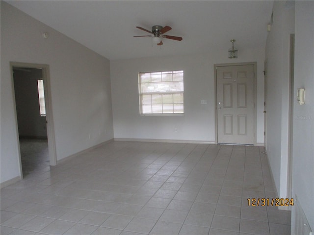 empty room featuring light tile patterned floors and ceiling fan