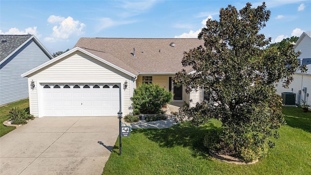 single story home featuring cooling unit, a garage, and a front lawn