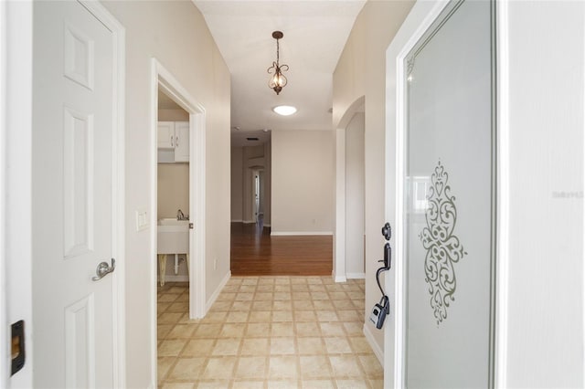 306 Bishopville Loop Unit 117, The Villages, FL 32162 - hallway featuring baseboards and arched walkways