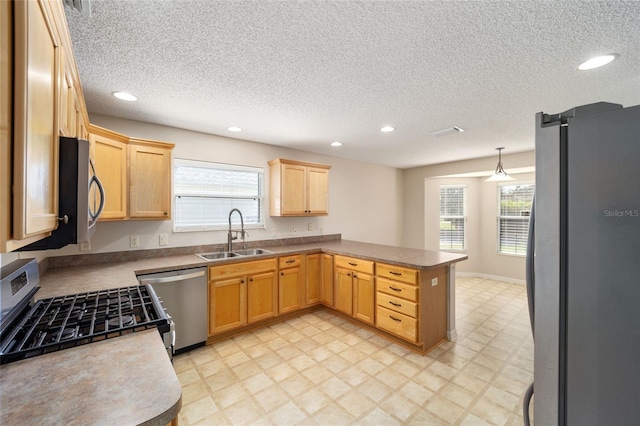 306 Bishopville Loop Unit 117, The Villages, FL 32162 - kitchen featuring a sink, a peninsula, stainless steel appliances, recessed lighting, and light brown cabinets