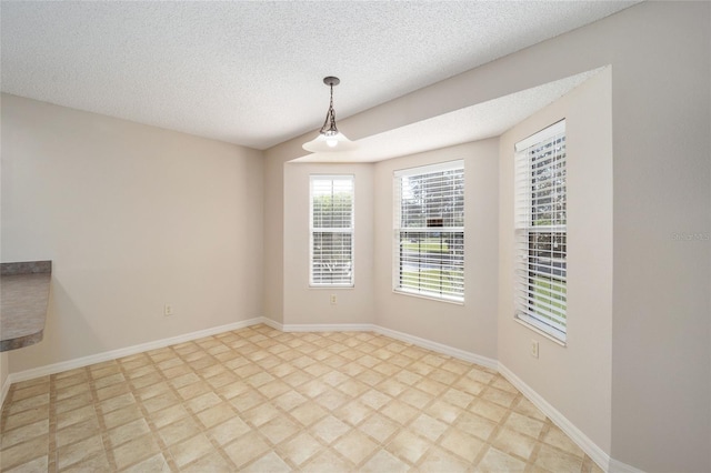 unfurnished room with a textured ceiling