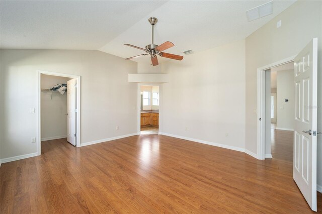306 Bishopville Loop Unit 117, The Villages, FL 32162 - interior space featuring vaulted ceiling, visible vents, light wood finished floors, and a walk in closet